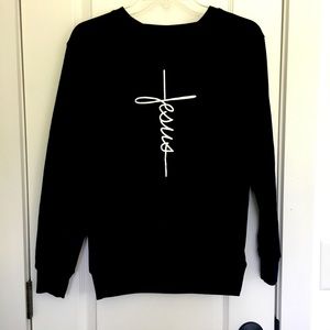 Black sweater with Jesus written down the middle in cross form